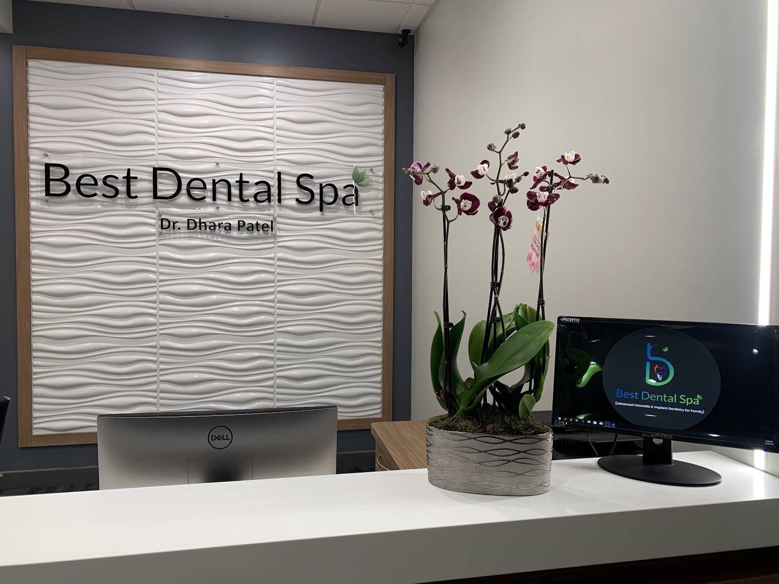 Best Dental Spa reception desk with the clinic name lit on a feature wall